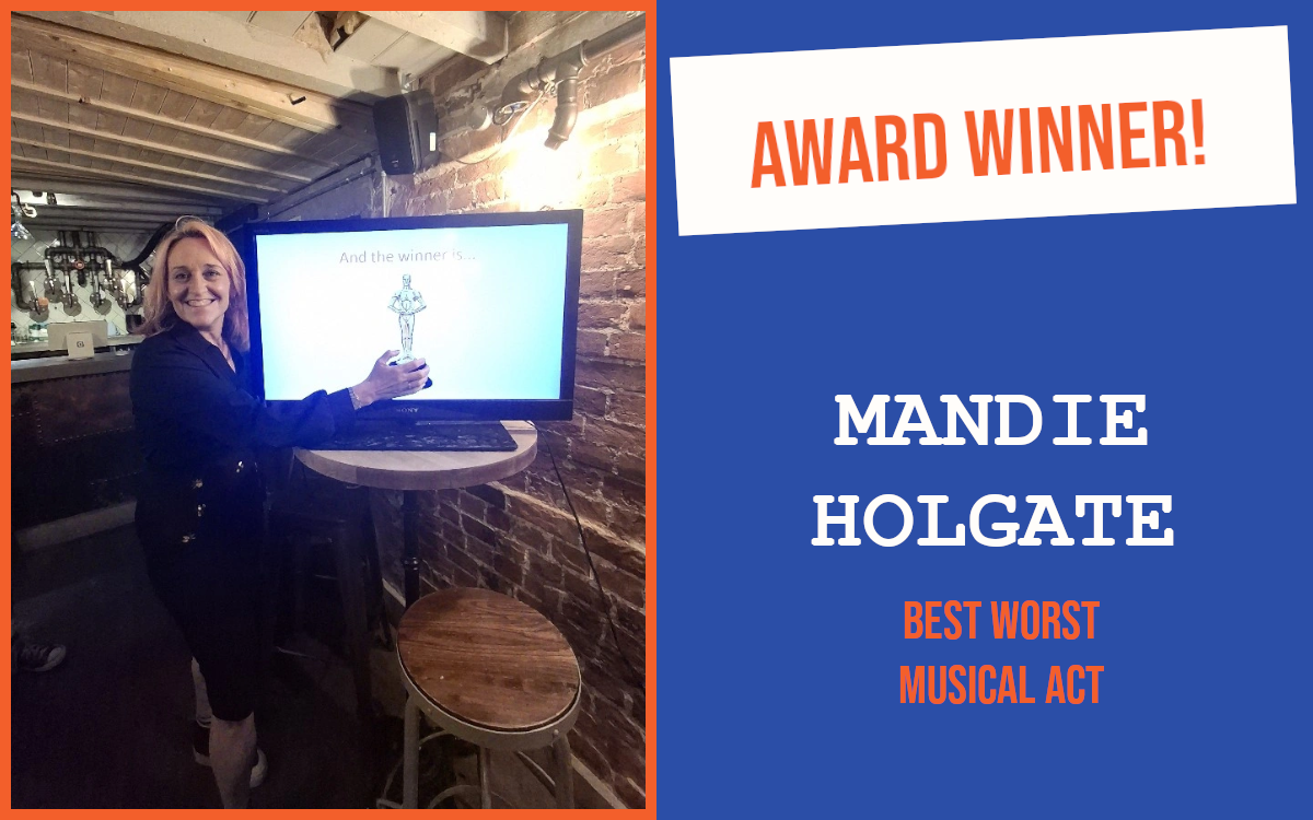 The winner of the Best Worst Musical Act question at the Colchester July networking meeting, pretending to hold a trophy on a screen.