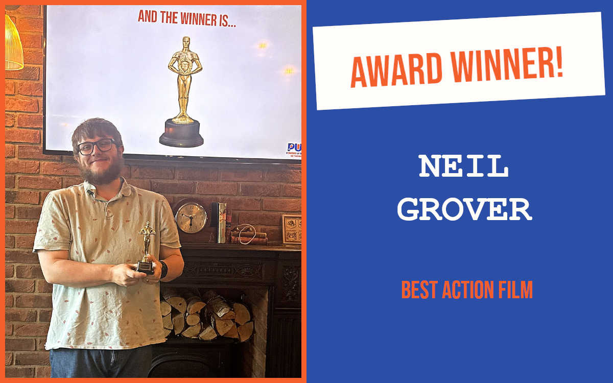 The winner of the networking question at the June edition of the Cambridge Pubnetworking event, holding the trophy and standing in front of a screen displaying a trophy.