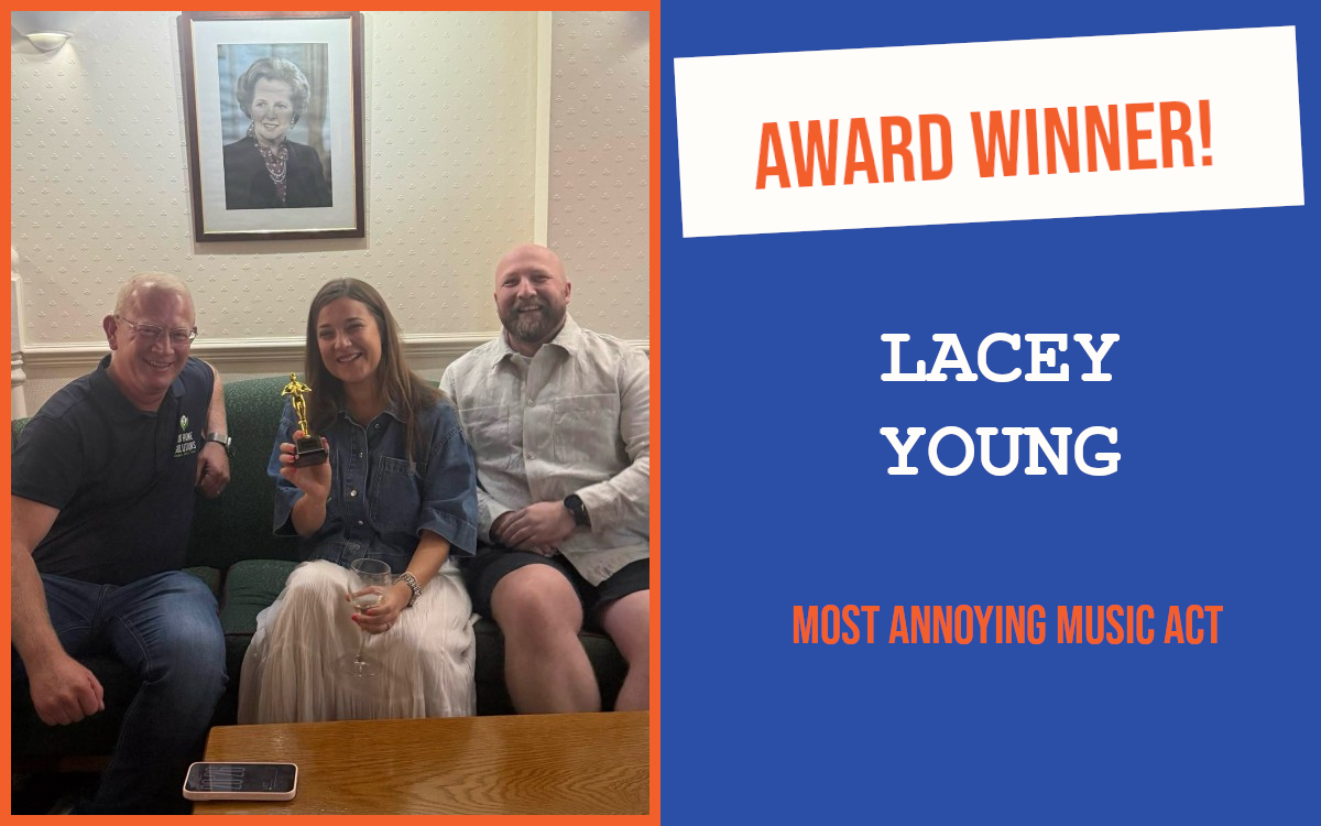 The winner of the networking question at the July meeting of the South East Essex networking event, sitting on a sofa holding the trophy, with the hosts either side.