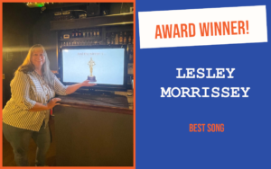 The winner of the introductory question at Chelmsford's September networking event, leaning on the bar and pretending to hold a trophy displayed on a screen.