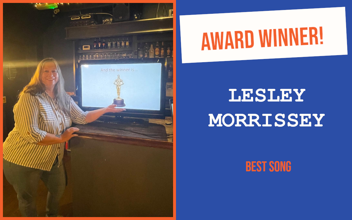 The winner of the introductory question at Chelmsford's September networking event, leaning on the bar and pretending to hold a trophy displayed on a screen.